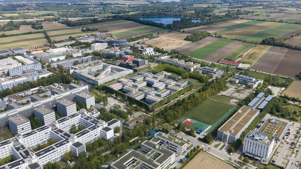 Unterfohring Germany 12 September 2026 Aerial view of the Allianz Commercial office campus with modern corporate buildings green roofs surrounding fields and sports facilities.