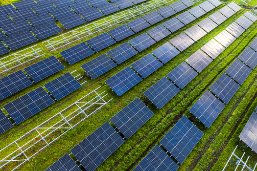 Aerial view of the FVE Bohumilice solar power plant with rows of photovoltaic panels and metal frames on green grass in Klobouky u Brna Jihomoravsky kraj Czechia. Aerial view of the FVE Bohumilice solar power plant with rows of photovoltaic panels and metal frames on green grass in Klobouky u Brna Jihomoravsky kraj Czechia.