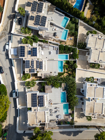 Aerial view of modern villas with swimming pools and solar panels in Moraira Valencian Community Spain.