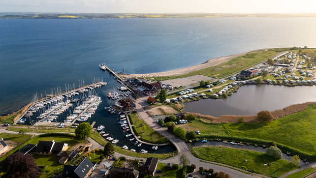 Aerial view of Langballigau harbor with sailboats docked in the marina and a campsite near the beach along the Baltic coast in Schleswig Flensburg Schleswig Holstein Germany.