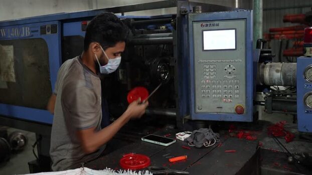 View of a worker operating an industrial machine in Jashore Bangladesh. View of a worker operating an industrial machine in Jashore Bangladesh.