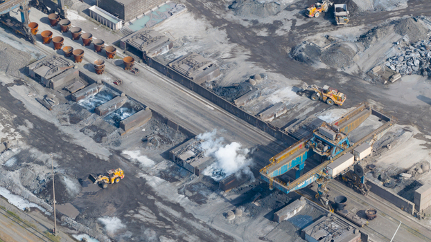 Aerial view of the Tata Steel industrial plant with heavy machinery smelting ladles and steam rising from the production area in Velsen Noord Noord Holland Netherlands. Aerial view of the Tata Steel industrial plant with heavy machinery smelting ladles and steam rising from the production area in Velsen Noord Noord Holland Netherlands.
