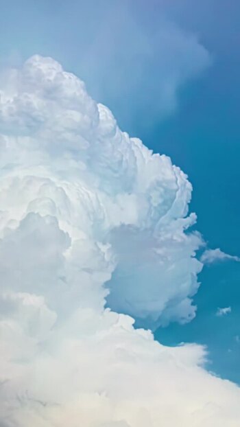 View of white cumulus clouds against a blue sky in Latvia. View of white cumulus clouds against a blue sky in Latvia.