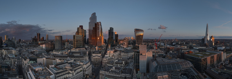 Aerial view of the London City skyline with the Shard and modern skyscrapers reflecting the golden light of sunset London London United Kingdom. Aerial view of the London City skyline with the Shard and modern skyscrapers reflecting the golden light of sunset London London United Kingdom.