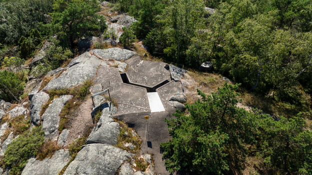 Aerial view of the historic concrete gun emplacement at Oro Fortress Island surrounded by rocky terrain and dense forest in Oro Varsinais Suomi Finland. Aerial view of the historic concrete gun emplacement at Oro Fortress Island surrounded by rocky terrain and dense forest in Oro Varsinais Suomi Finland.
