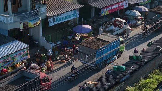 Aerial view of a busy street market with trucks Indonesia.