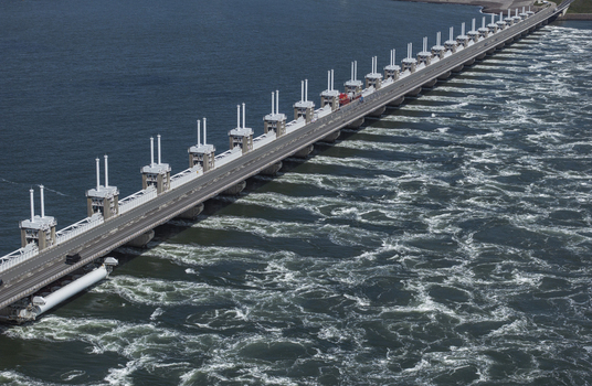 Aerial view of the Eastern Scheldt Storm Surge Barrier with its massive sluice gates and turbulent water currents in Vrouwenpolder Zeeland Netherlands. Aerial view of the Eastern Scheldt Storm Surge Barrier with its massive sluice gates and turbulent water currents in Vrouwenpolder Zeeland Netherlands.