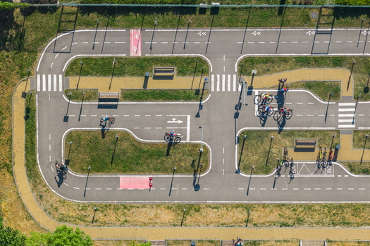 Aerial view of a children s traffic playground with miniature roads crosswalks and cyclists on a sunny day in Kyjov South Moravian Region Czechia.