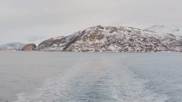 View of snow covered mountains over water Norway.