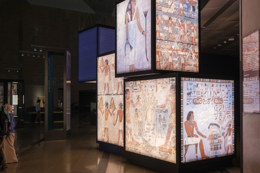 Giza Egypt 16 May 2026 View of the Grand Egyptian Museum featuring illuminated panels with ancient Egyptian tomb paintings and hieroglyphs in a modern exhibition hall.