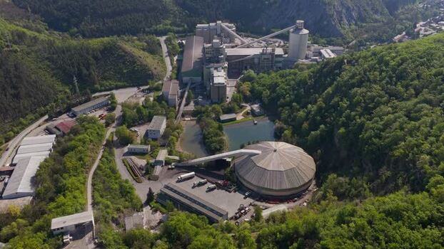 Aerial view of an industrial cement plant in a green valley Czechia. Aerial view of an industrial cement plant in a green valley Czechia.