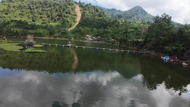 Aerial view of Rawa Gede Jonggol Lake and lush green hills Indonesia.