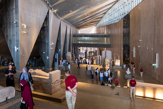 Giza Governorate Egypt 16 May 2026 View of the Grand Egyptian Museum interior with ancient statues and visitors walking through the modern architectural hall. Giza Governorate Egypt 16 May 2026 View of the Grand Egyptian Museum interior with ancient statues and visitors walking through the modern architectural hall.