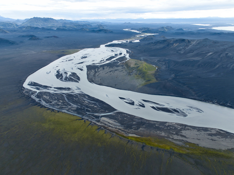 Aerial view of Skyggnisvatn featuring a braided river flowing through a volcanic landscape with dark sand and patches of green moss in Hella Rangarthing ytra Iceland. Aerial view of Skyggnisvatn featuring a braided river flowing through a volcanic landscape with dark sand and patches of green moss in Hella Rangarthing ytra Iceland.