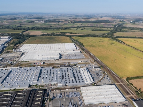 Aerial view of the Volkswagen plant near Devinska Nova Ves with large industrial buildings and parking lots surrounded by fields in Bratislava Bratislavsky kraj Slovakia. Aerial view of the Volkswagen plant near Devinska Nova Ves with large industrial buildings and parking lots surrounded by fields in Bratislava Bratislavsky kraj Slovakia.