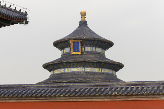 View of the Hall of Prayer for Good Harvests at the Temple of Heaven featuring its iconic blue tiled roof and golden finial Beijing Beijing China. View of the Hall of Prayer for Good Harvests at the Temple of Heaven featuring its iconic blue tiled roof and golden finial Beijing Beijing China.