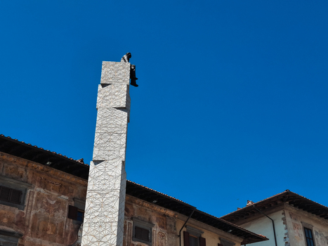 Pisa Italy 27 April 2026 View of a modern geometric sculpture with a figure sitting on top set against a clear blue sky and historic buildings in Pisa. Pisa Italy 27 April 2026 View of a modern geometric sculpture with a figure sitting on top set against a clear blue sky and historic buildings in Pisa.