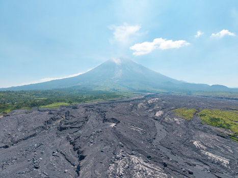 Aerial view of Mount Semeru with volcanic ash deposits and scarred landscape following a catastrophic eruption near Supiturang Village in Pronojiwo East Java Indonesia.