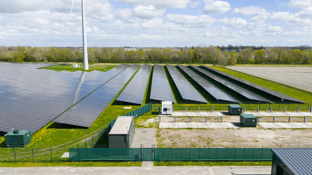 Aerial view of battery storage and mobile container charging at De Dijken Solar Park near Warmenhuizen supporting grid balance renewable energy and flexible power use. Aerial view of battery storage and mobile container charging at De Dijken Solar Park near Warmenhuizen supporting grid balance renewable energy and flexible power use.