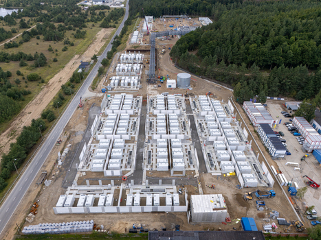 Aerial view of Zarnowiec Pumped Storage Power Plant construction site featuring rows of white energy storage containers and heavy machinery in Wejherowo County Pomeranian Voivodeship Poland.