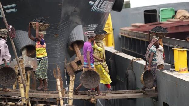 View of workers carrying coal baskets at Aminbazar Bangladesh. View of workers carrying coal baskets at Aminbazar Bangladesh.