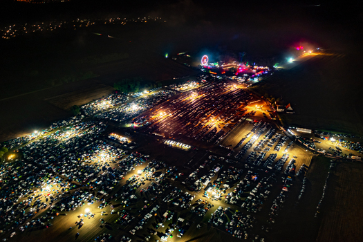 Herzogenaurach Germany 22 July 2022 Aerial view of the Open Beatz Festival featuring illuminated tents a Ferris wheel and vibrant lights across the festival grounds at night. Herzogenaurach Germany 22 July 2022 Aerial view of the Open Beatz Festival featuring illuminated tents a Ferris wheel and vibrant lights across the festival grounds at night.