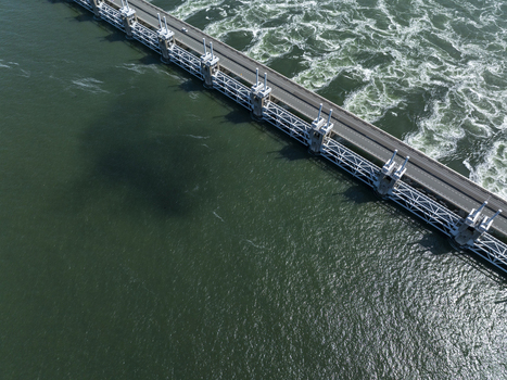 Aerial view of the Eastern Scheldt Storm Surge Barrier with its massive sluice gates and road bridge spanning the turbulent waters in Vrouwenpolder Zeeland Netherlands. Aerial view of the Eastern Scheldt Storm Surge Barrier with its massive sluice gates and road bridge spanning the turbulent waters in Vrouwenpolder Zeeland Netherlands.