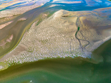 Aerial view of Baie de Somme showing intricate sand patterns tidal channels and shallow water in Saint Valery sur Somme Hauts de France France. Aerial view of Baie de Somme showing intricate sand patterns tidal channels and shallow water in Saint Valery sur Somme Hauts de France France.