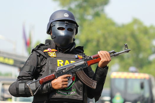 Dhaka Bangladesh 08 January 2017 View of a member of the Rapid Action Battalion RAB special force in full tactical gear and face shield holding a rifle at the RAB Headquarters. Dhaka Bangladesh 08 January 2017 View of a member of the Rapid Action Battalion RAB special force in full tactical gear and face shield holding a rifle at the RAB Headquarters.
