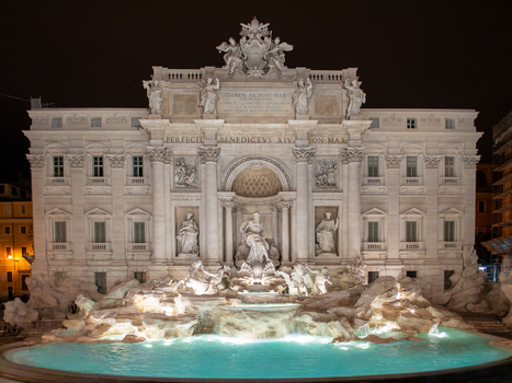 View of the illuminated Trevi Fountain at night featuring detailed baroque sculptures and the central water basin in Rome Lazio Italy. View of the illuminated Trevi Fountain at night featuring detailed baroque sculptures and the central water basin in Rome Lazio Italy.