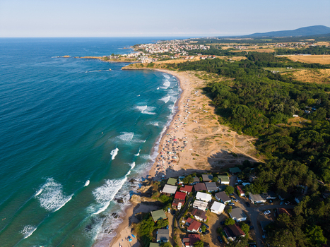 Aerial view of Coral Beach with its sandy coastline turquoise sea and holiday bungalows nestled in the forest in Tsarevo Burgas Bulgaria. Aerial view of Coral Beach with its sandy coastline turquoise sea and holiday bungalows nestled in the forest in Tsarevo Burgas Bulgaria.