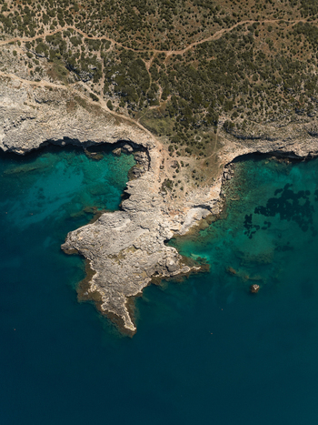 Aerial view of the rugged rocky coastline and turquoise waters of the Marine Protected Area of Plemmirio Sicily Italy. Aerial view of the rugged rocky coastline and turquoise waters of the Marine Protected Area of Plemmirio Sicily Italy.