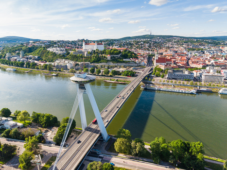 Aerial view of the SNP Bridge with its UFO observation deck crossing the Danube River towards Bratislava Castle on the hill in Bratislava Bratislava Region Slovakia. Aerial view of the SNP Bridge with its UFO observation deck crossing the Danube River towards Bratislava Castle on the hill in Bratislava Bratislava Region Slovakia.