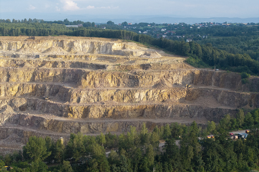 Aerial view of the Porphyry and Diabase Mine featuring terraced rock excavations and surrounding forest in Krakow Lesser Poland Voivodeship Poland. Aerial view of the Porphyry and Diabase Mine featuring terraced rock excavations and surrounding forest in Krakow Lesser Poland Voivodeship Poland.
