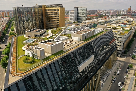 Aerial view of the Axel Springer Neubau featuring a modern green rooftop garden and glass facade overlooking the urban cityscape in Berlin Berlin Germany. Aerial view of the Axel Springer Neubau featuring a modern green rooftop garden and glass facade overlooking the urban cityscape in Berlin Berlin Germany.