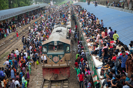 Dhaka Bangladesh 15 June 2018 View of the crowded Airport Railway Station with thousands of passengers on platforms and train roofs during the Eid rush. Dhaka Bangladesh 15 June 2018 View of the crowded Airport Railway Station with thousands of passengers on platforms and train roofs during the Eid rush.