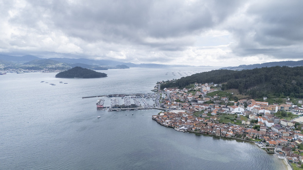 Aerial view of the historic fishing village of Combarro and its marina along the calm waters of the bay under a cloudy sky Combarro Pontevedra Spain. Aerial view of the historic fishing village of Combarro and its marina along the calm waters of the bay under a cloudy sky Combarro Pontevedra Spain.