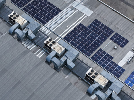 Aerial view of industrial rooftop featuring solar panels and HVAC units in Melbourne VIC Australia.