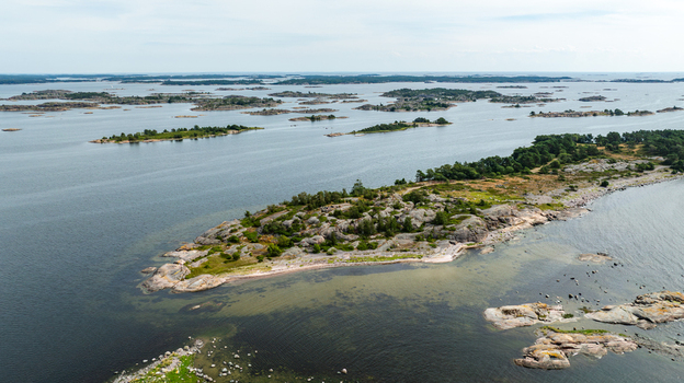 Aerial view of the rocky coastline and lush vegetation of Oro Fortress Island surrounded by the calm waters of the Baltic Sea and scattered islands in Oro Varsinais Suomi Finland. Aerial view of the rocky coastline and lush vegetation of Oro Fortress Island surrounded by the calm waters of the Baltic Sea and scattered islands in Oro Varsinais Suomi Finland.