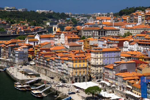 Aerial view of terracotta rooftops cascade down to the waterfront a vibrant tapestry against the deep blue Douro River Porto Porto District Portugal. Aerial view of terracotta rooftops cascade down to the waterfront a vibrant tapestry against the deep blue Douro River Porto Porto District Portugal.