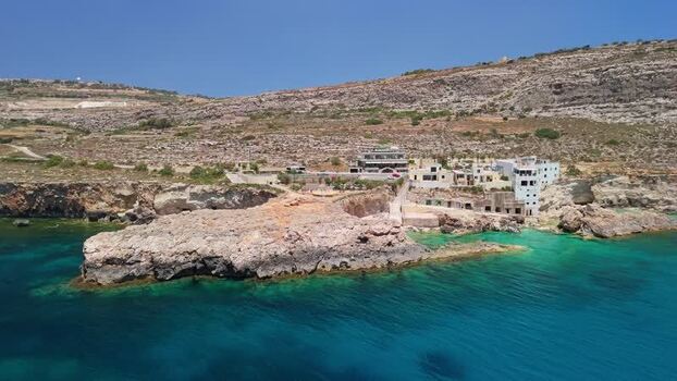 Aerial view of Ghar Lapsi bay in Malta with cliffs and turquoise water Aerial view of Ghar Lapsi bay in Malta with cliffs and turquoise water