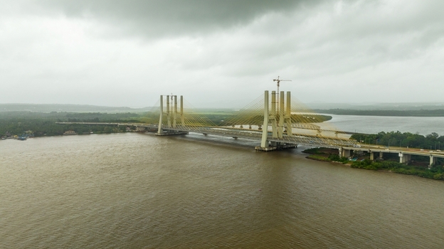 Aerial view of the Zuari Bridge spanning the Zuari River under a cloudy sky in Cortalim Goa India.