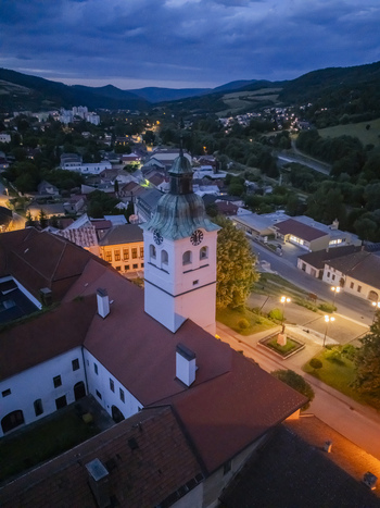 Aerial view of the illuminated town nestled in the valley centered around the prominent church tower Gelnica Kosice Region Slovakia. Aerial view of the illuminated town nestled in the valley centered around the prominent church tower Gelnica Kosice Region Slovakia.