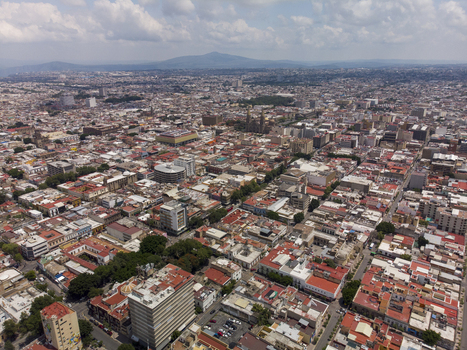 Aerial view of the historic Centro district featuring dense urban architecture colonial buildings and red tiled rooftops under a cloudy sky in Guadalajara Jalisco Mexico. Aerial view of the historic Centro district featuring dense urban architecture colonial buildings and red tiled rooftops under a cloudy sky in Guadalajara Jalisco Mexico.