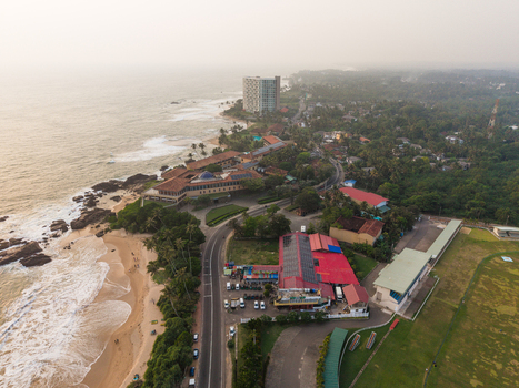 Aerial view of the tropical coastline with sandy beaches crashing waves coastal roads and lush green vegetation in Galle Southern Province Sri Lanka.