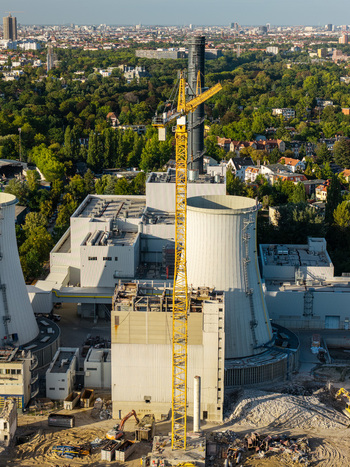 Aerial view of the Lichterfelde Power Station in Berlin during deconstruction featuring a yellow crane cooling towers and surrounding urban landscape in Berlin Berlin Germany. Aerial view of the Lichterfelde Power Station in Berlin during deconstruction featuring a yellow crane cooling towers and surrounding urban landscape in Berlin Berlin Germany.