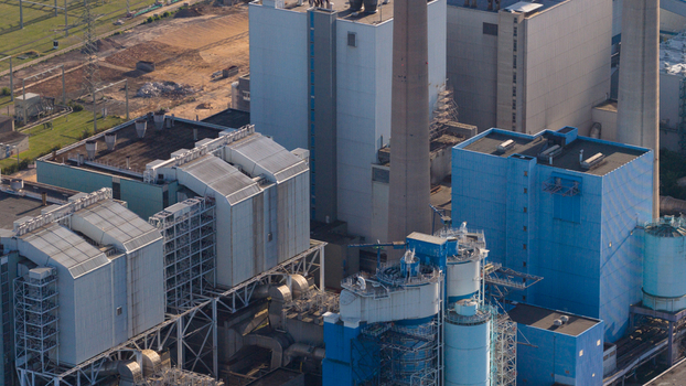 Aerial view of the Uniper Kraftwerke GmbH Kraftwerk Staudinger power plant featuring large industrial buildings and tall chimneys in Grosskrotzenburg Hessen Germany. Aerial view of the Uniper Kraftwerke GmbH Kraftwerk Staudinger power plant featuring large industrial buildings and tall chimneys in Grosskrotzenburg Hessen Germany.