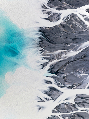 Aerial view of glacial rivers create an abstract painting with turquoise waters meeting the stark grey gravel plains Lake Tekapo Canterbury Region New Zealand. Aerial view of glacial rivers create an abstract painting with turquoise waters meeting the stark grey gravel plains Lake Tekapo Canterbury Region New Zealand.