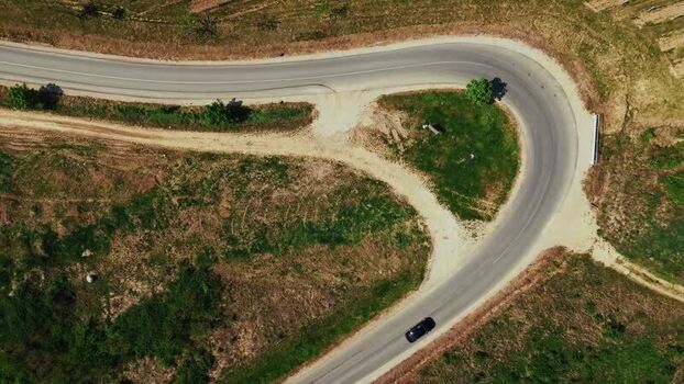 Aerial view of a winding road through a vineyard in Serbia.