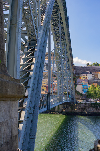 Porto Portugal 13 July 2021 View of the majestic Dom Luís I Bridge its intricate steel framework soaring above the shimmering Douro River connecting the vibrant cityscape. Porto Portugal 13 July 2021 View of the majestic Dom Luís I Bridge its intricate steel framework soaring above the shimmering Douro River connecting the vibrant cityscape.